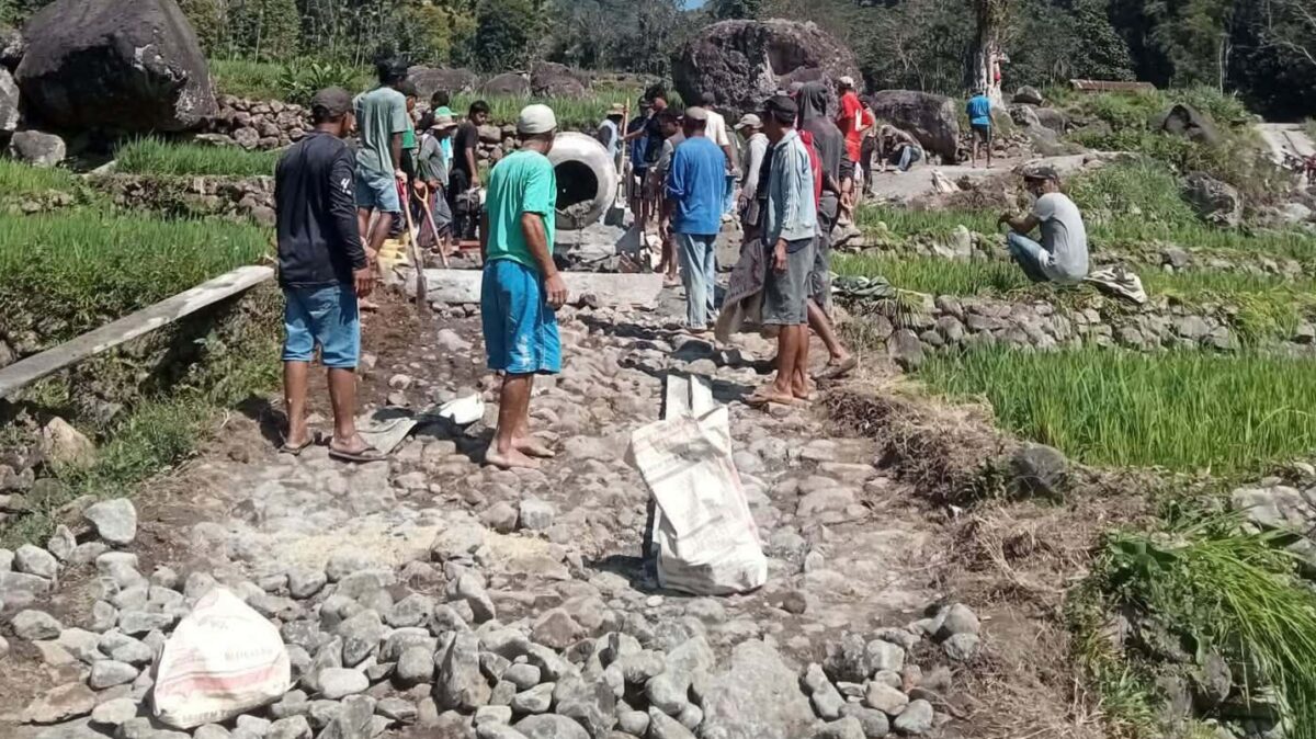 Warga bergotong royong mengerjakan pembangunan jalan rabat beton secara swadaya (Hariancerdas.com)